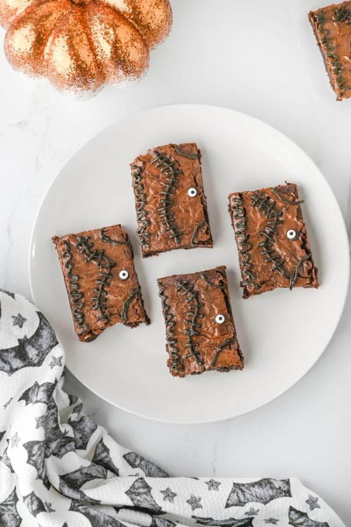 Four spell book brownies on a plate.