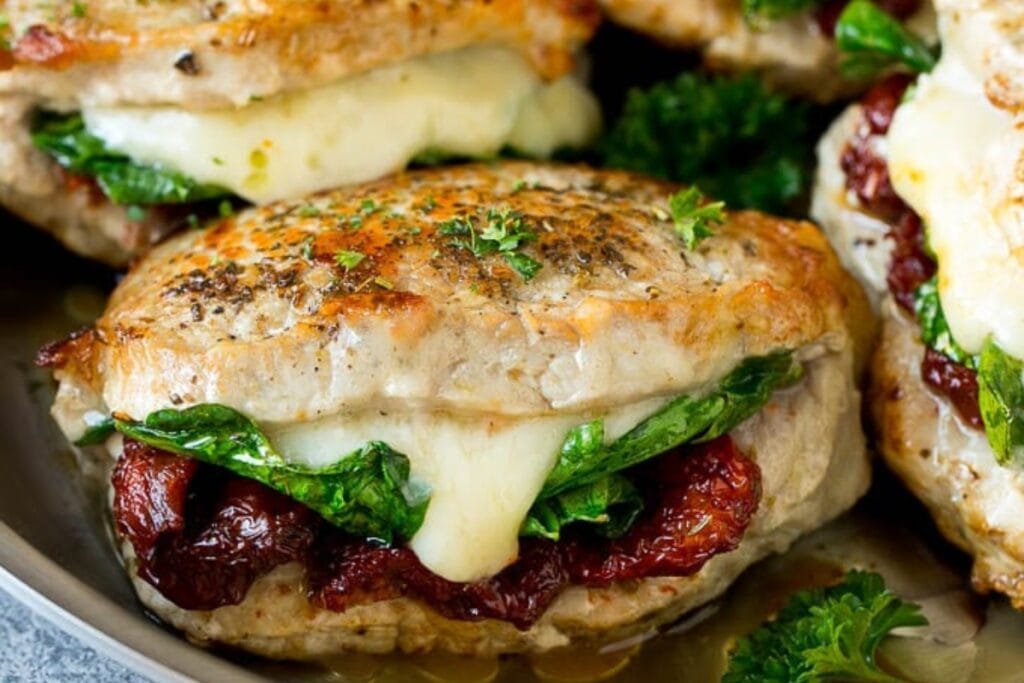 Stuffed pork chops on a skillet.