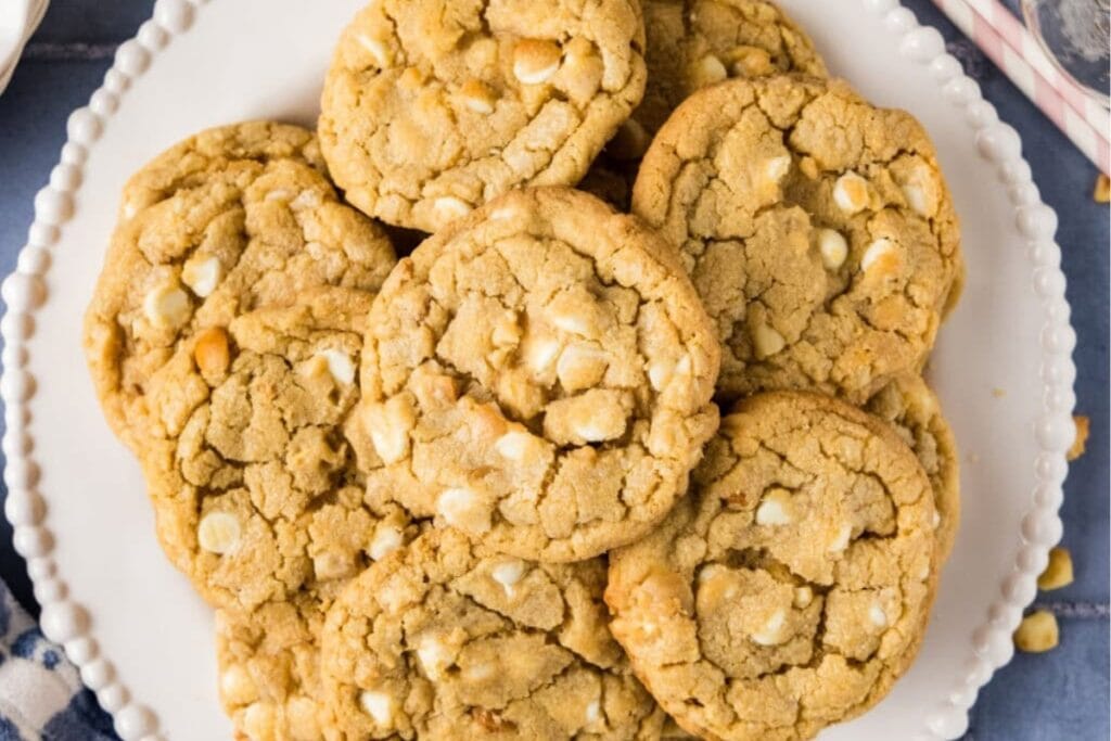 White chocolate macadamia nut cookies on a white plate.