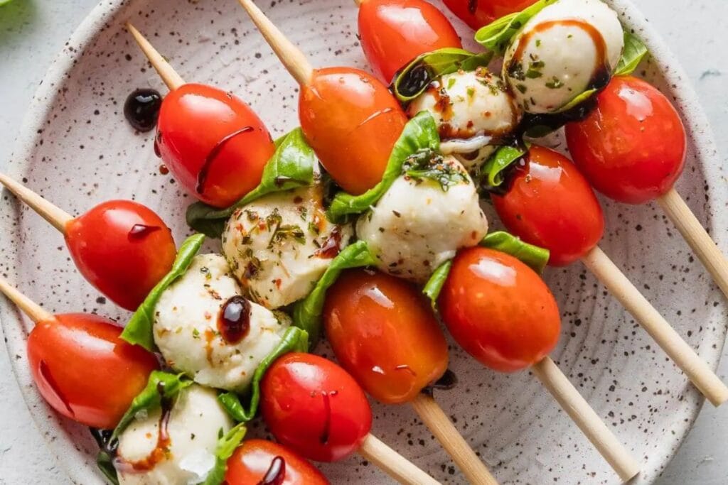 Caprese skewers on a plate.