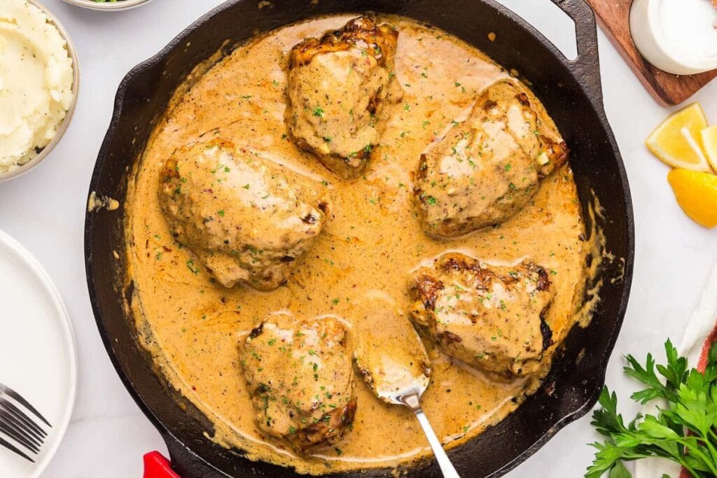 Chicken thighs with sauce in cast iron.