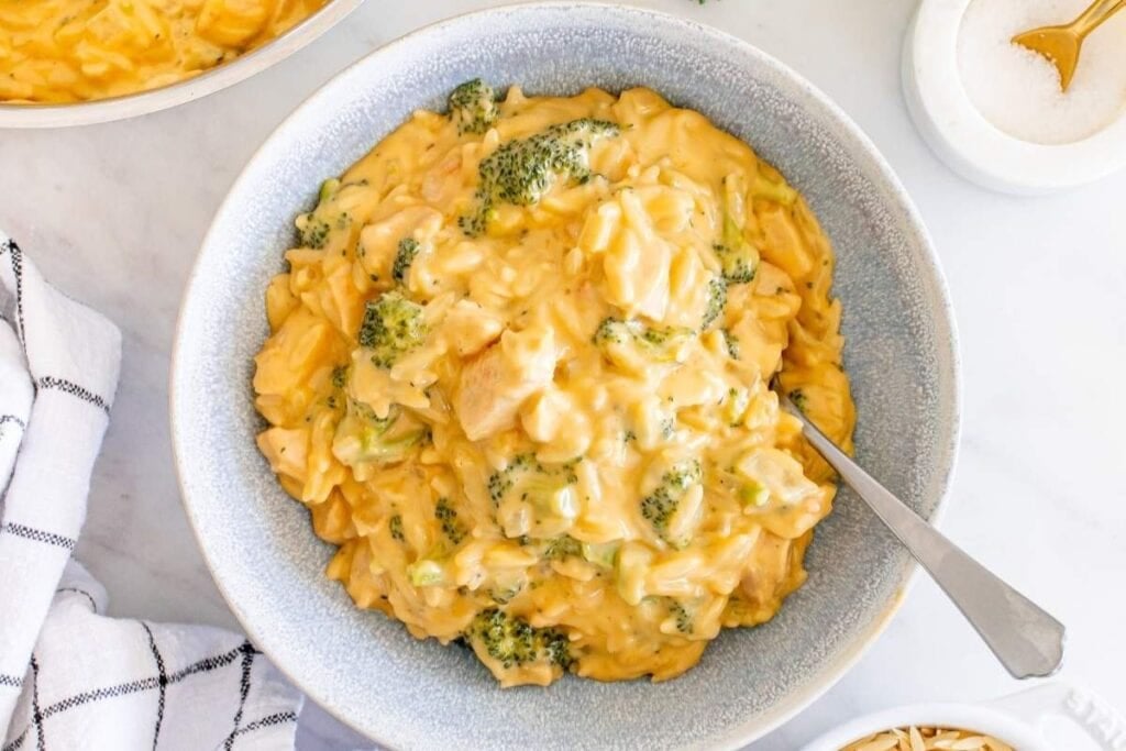 A bowl of chicken broccoli orzo.