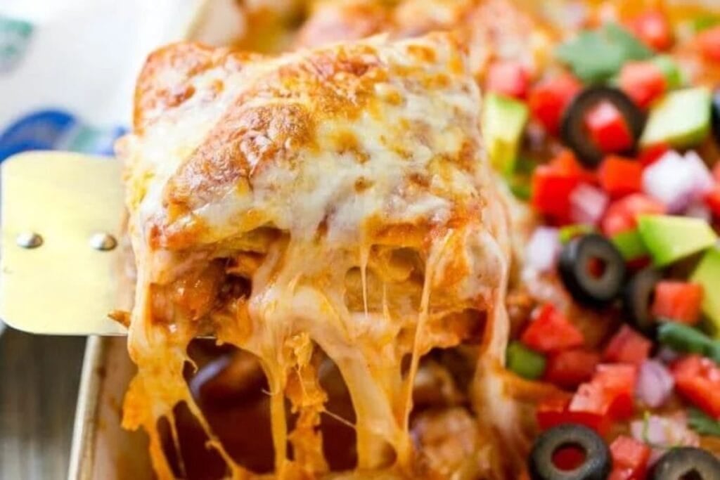 Chicken enchilada casserole with pulled cheese.