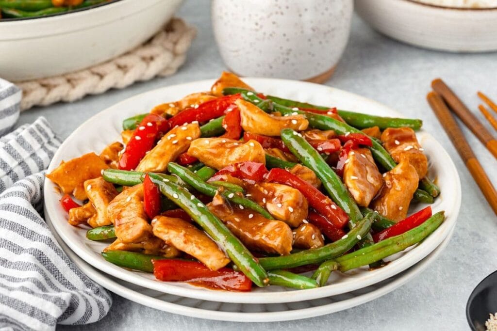 Chicken and green bean on a plate.