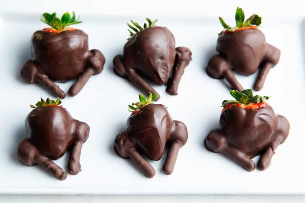 Chocolate covered strawberry turkey on a white surface.