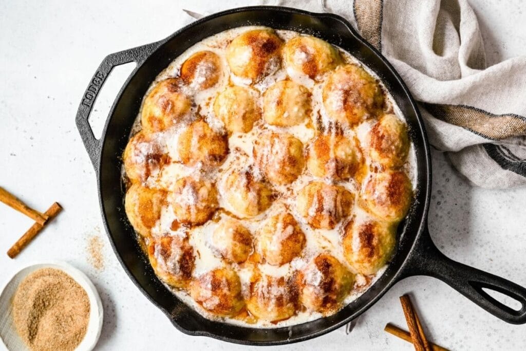 Cinnamon roll bites in a cast iron.