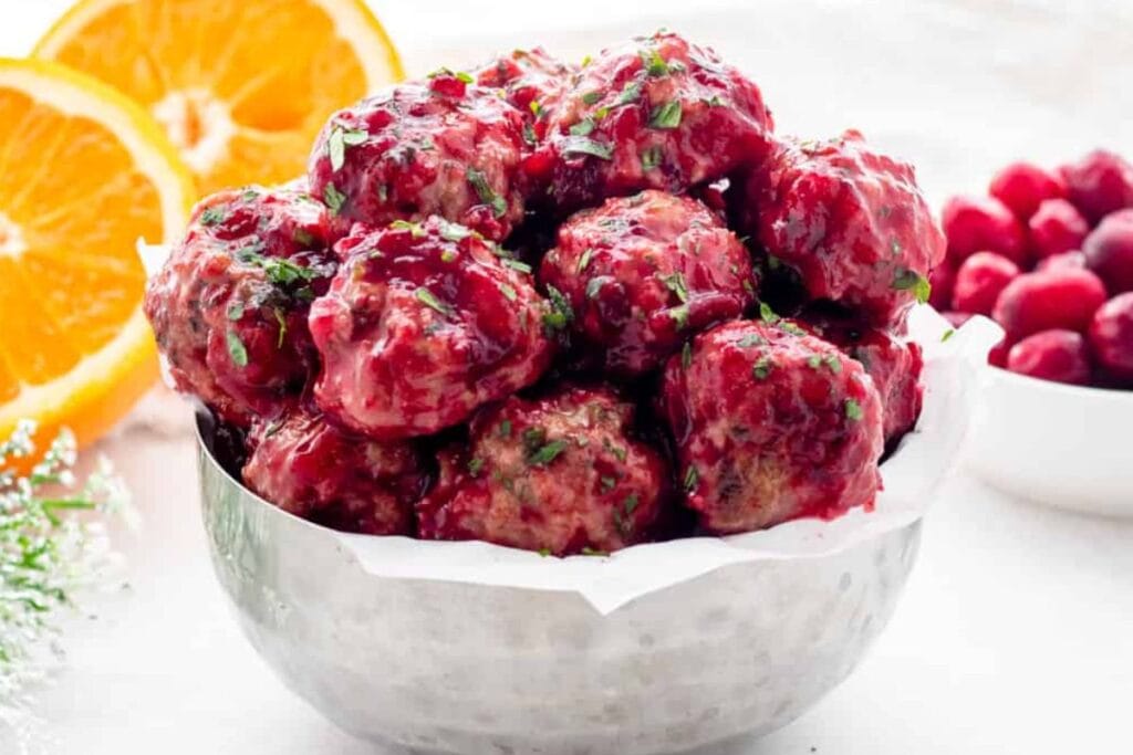 A bowl of cranberry chicken meatballs.