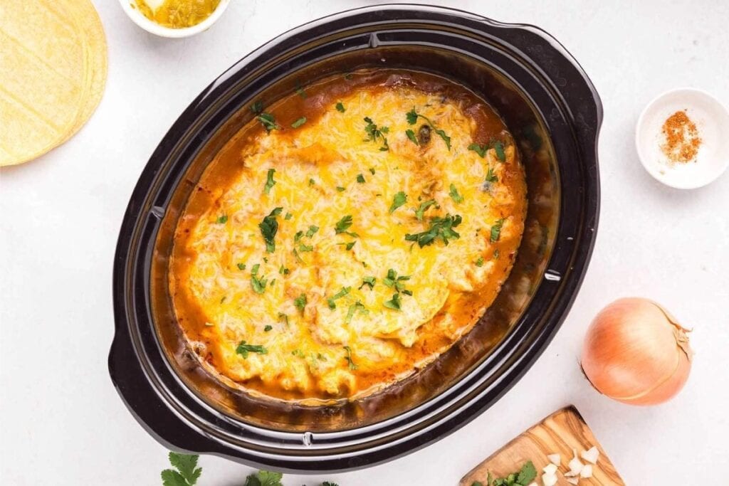 Chicken enchilada casserole in slow cooker.
