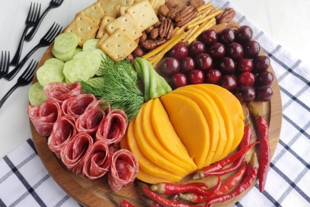 Fall charcuterie board on a checkered cloth.