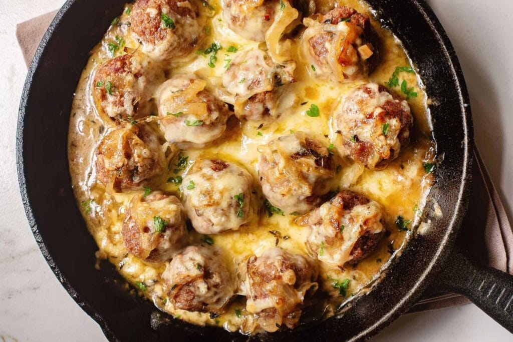 French onion meatballs in a cast iron.