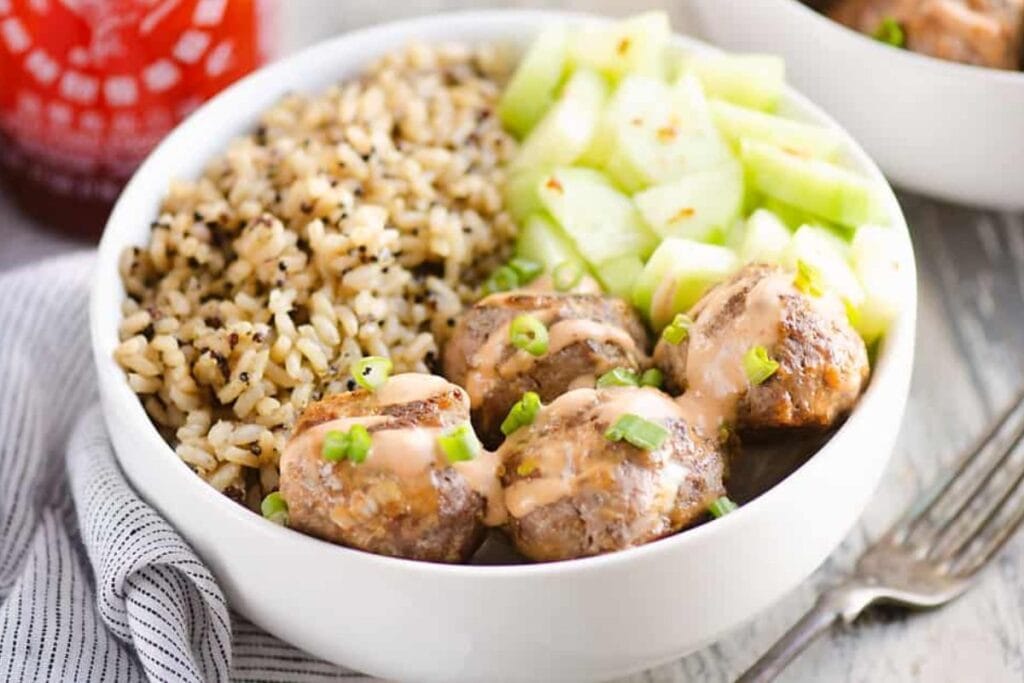 A bowl of honey sriracha meatballs.