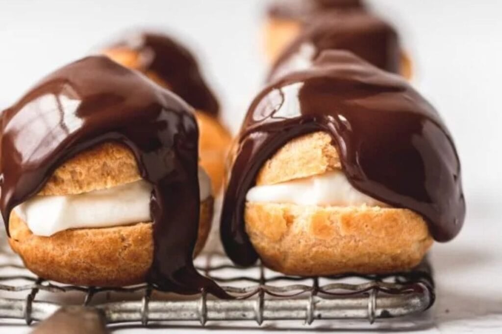 Cream puffs covered in chocolate.