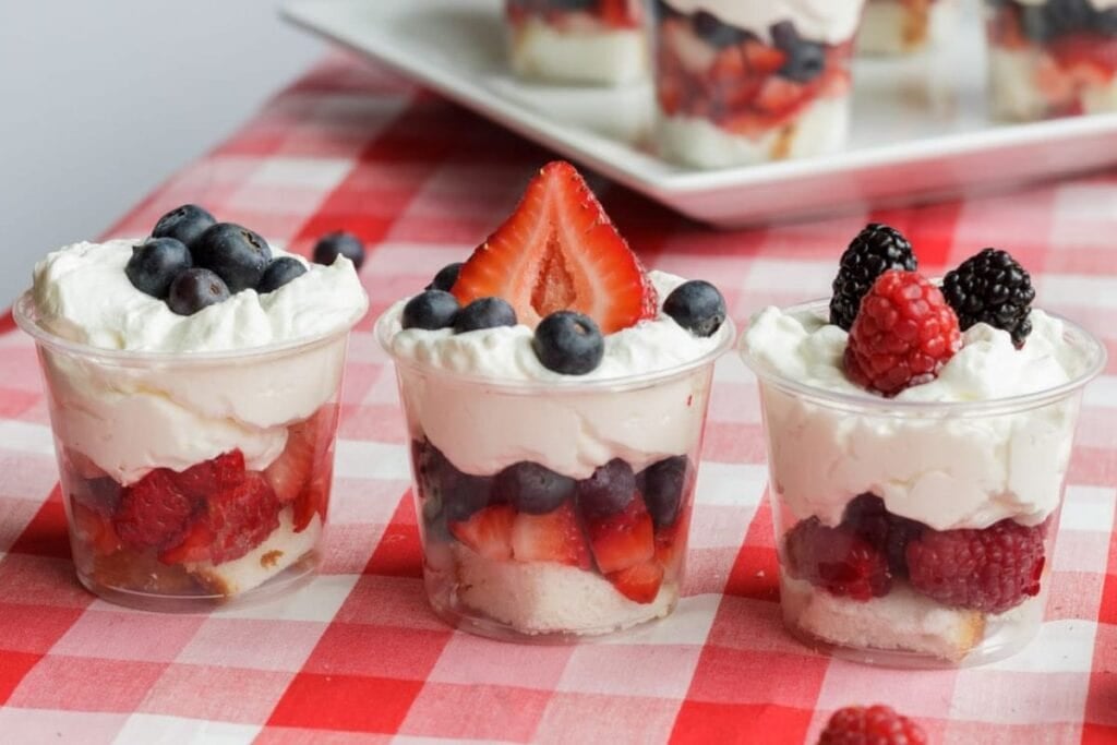 Mini shortcake cups on a checkered surface.