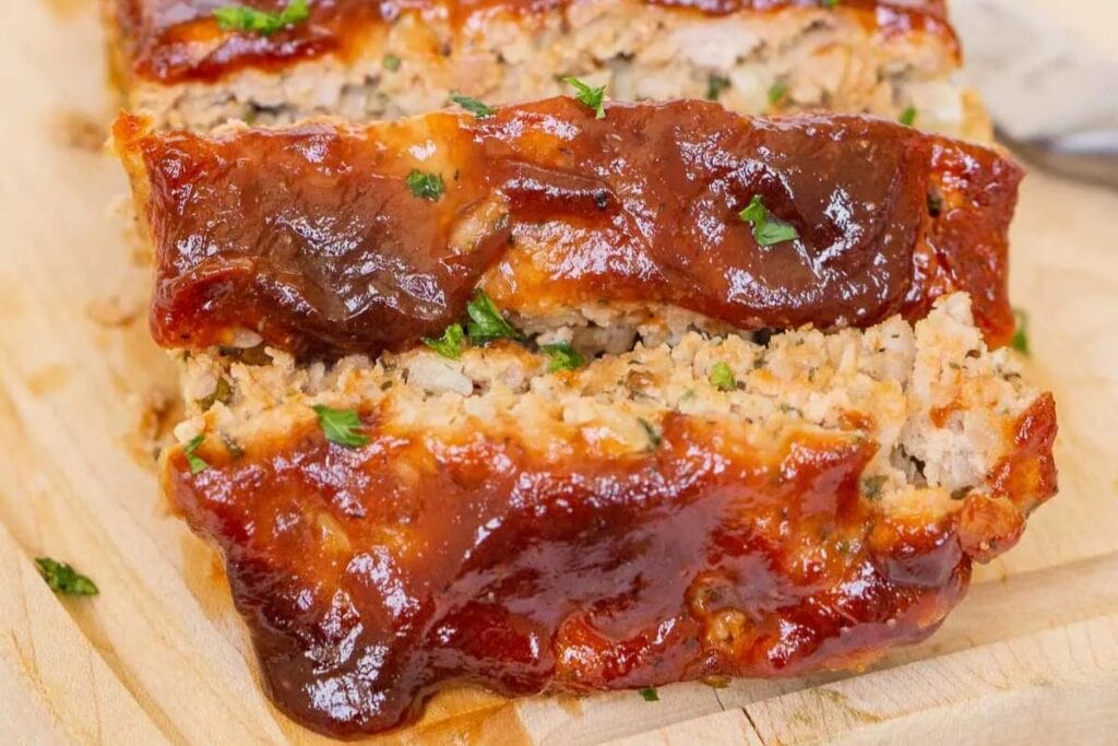 A close up shot of sliced pork meatloaf.