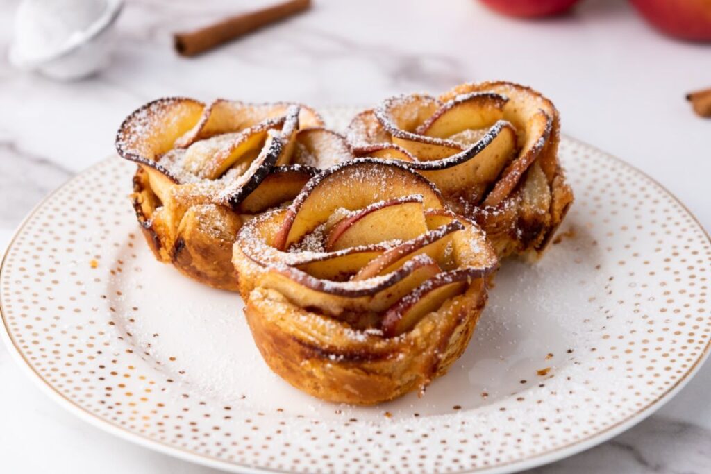 Puff pastry apple roses on a plate.