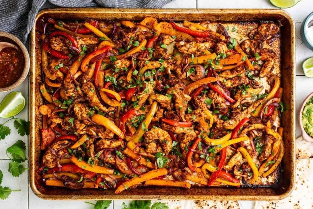 Chicken fajitas on a sheet pan.
