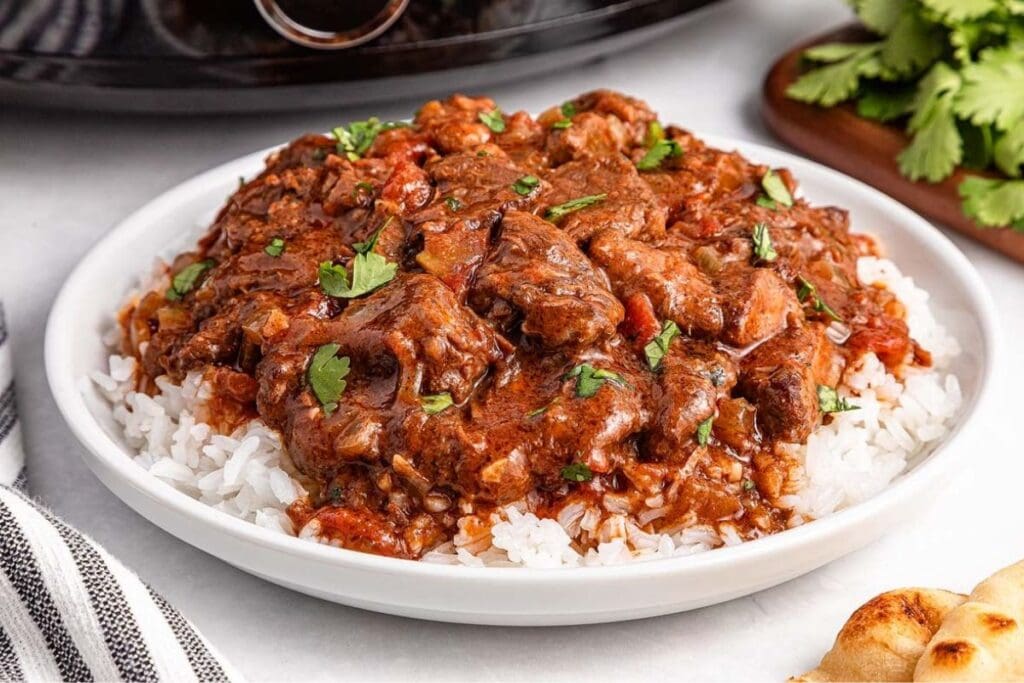Beef curry and rice on a plate.