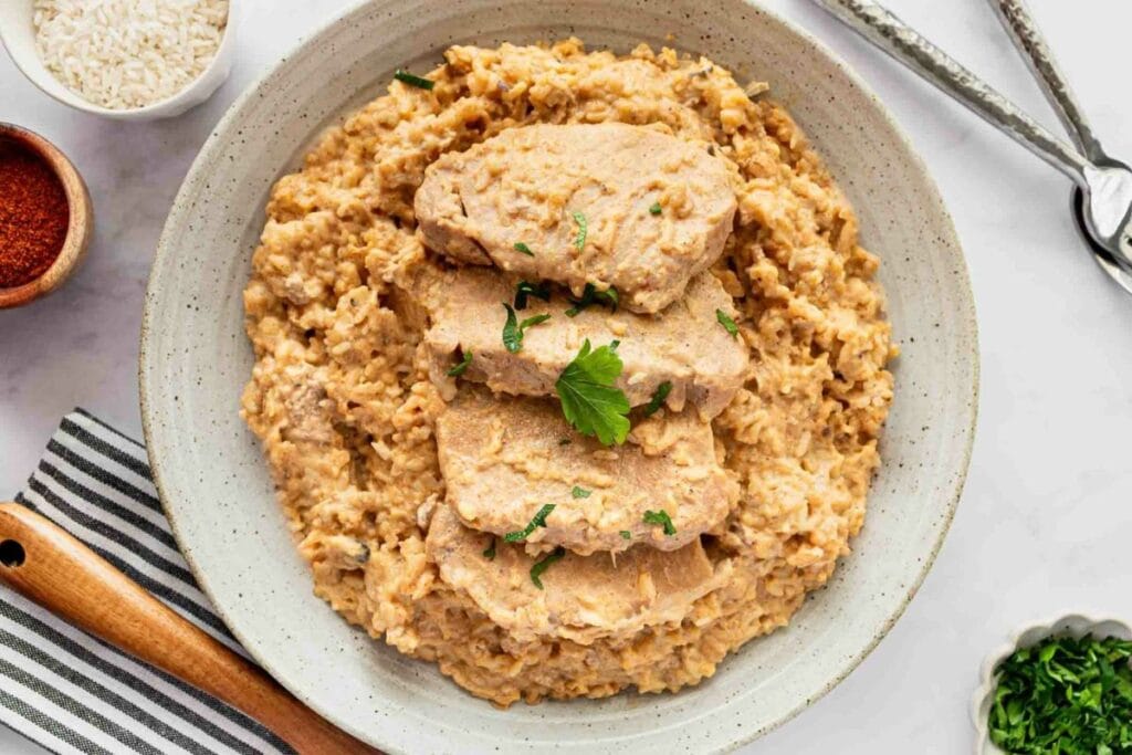 A bowl of pork chops and rice.