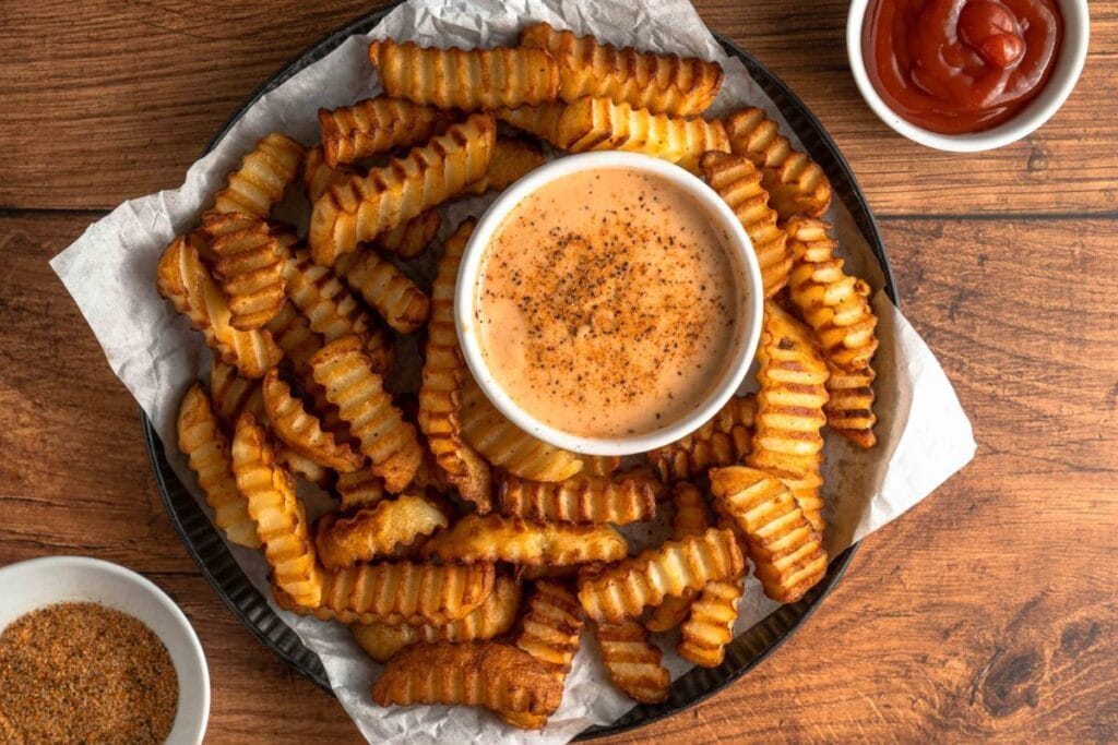 Close up shot of fries with sauce.