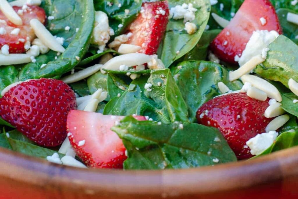 A close up shot of strawberry spinach salad.