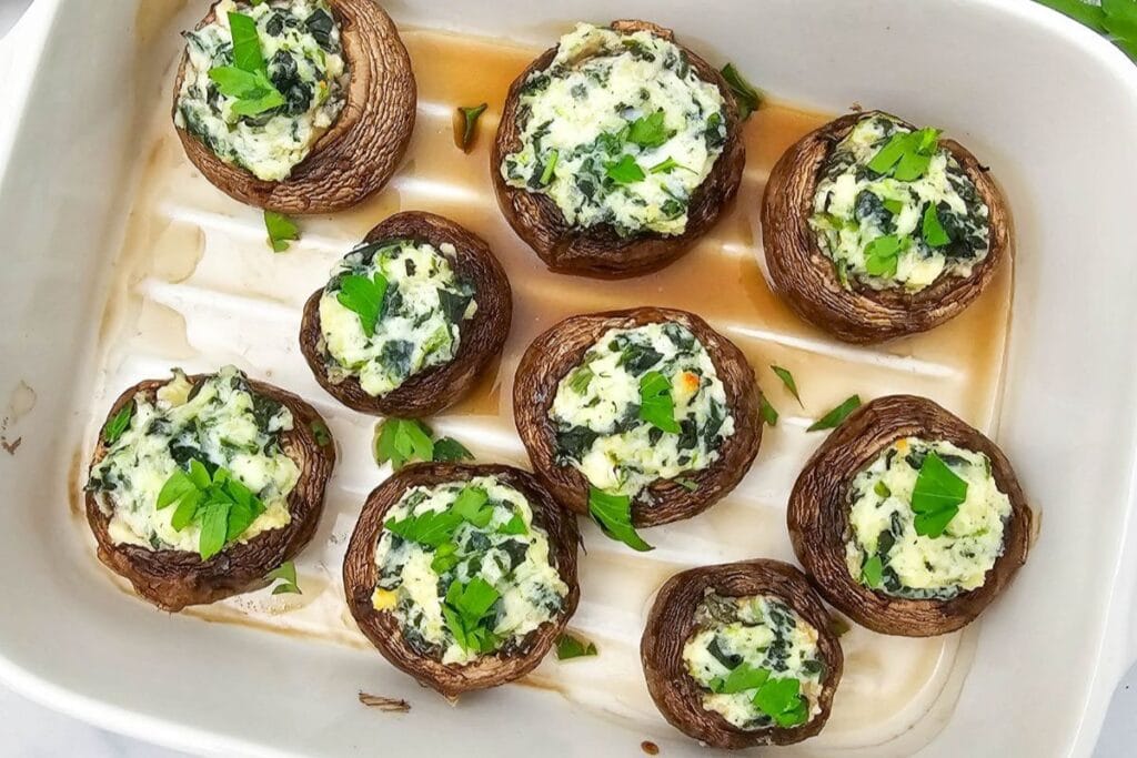 Stuffed mushrooms on a white dish.