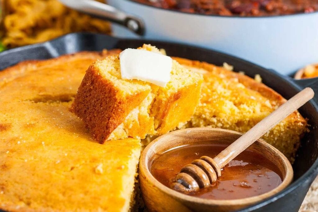 Skillet cornbread with honey on the side.