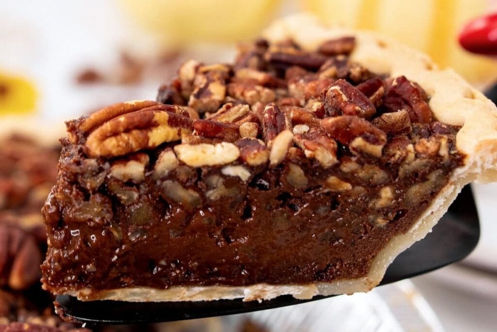 A slice of Texas chocolate pie with pecans.