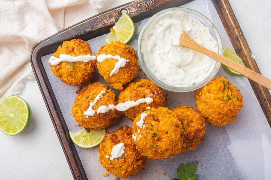 Air-fried Mac and Cheese Balls served on a tray with dipping sauce.