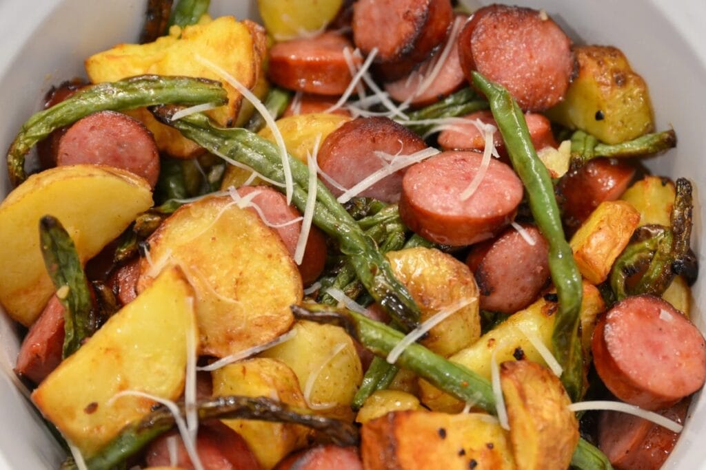 Air fryer sausage, green beans, and potatoes served in a bowl.