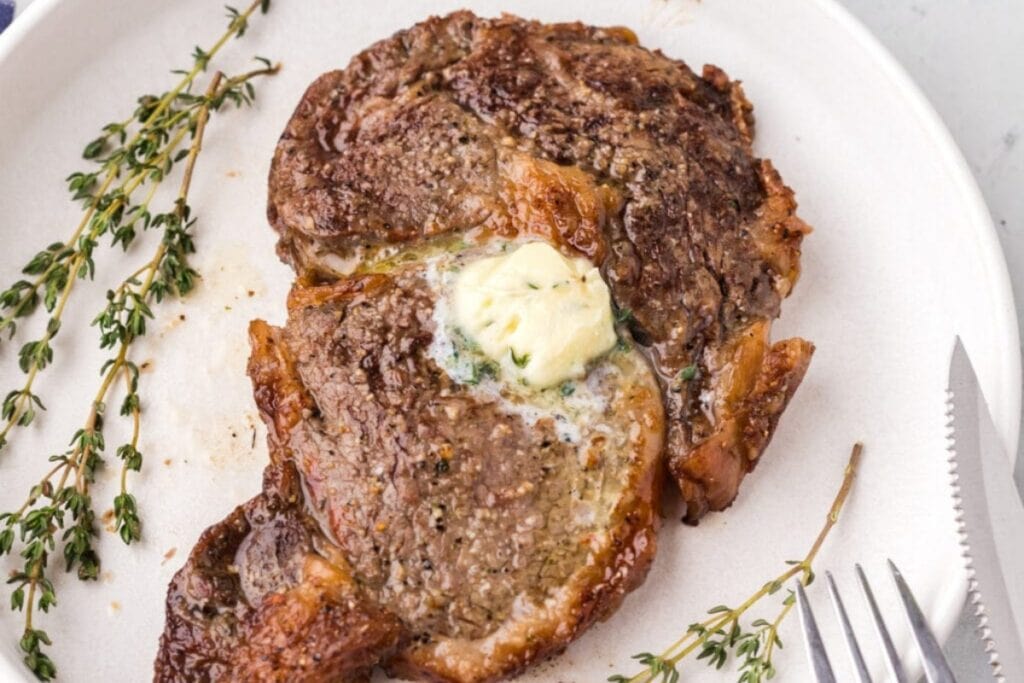 Juicy Air Fryer Steak plated on white dish.