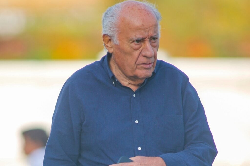 Amancio Ortega wearing a blue long-sleeve shirt.