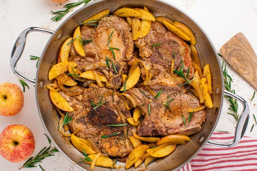 Apple butter pork chops in a skillet.