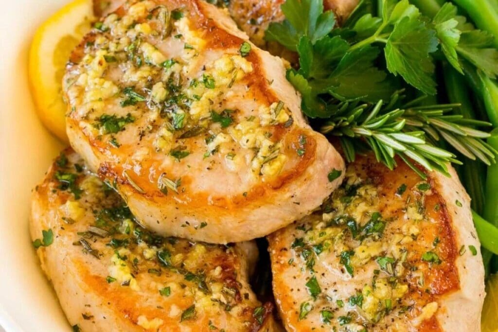 Baked pork chops on a plate.
