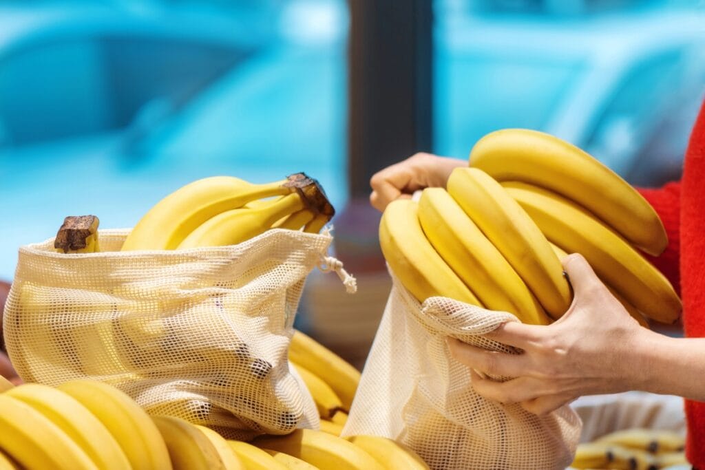 Person holding bananas.