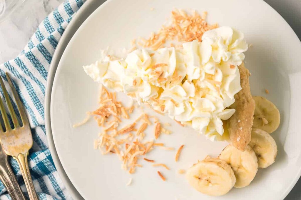 Slice of banana cream pie on a plate.