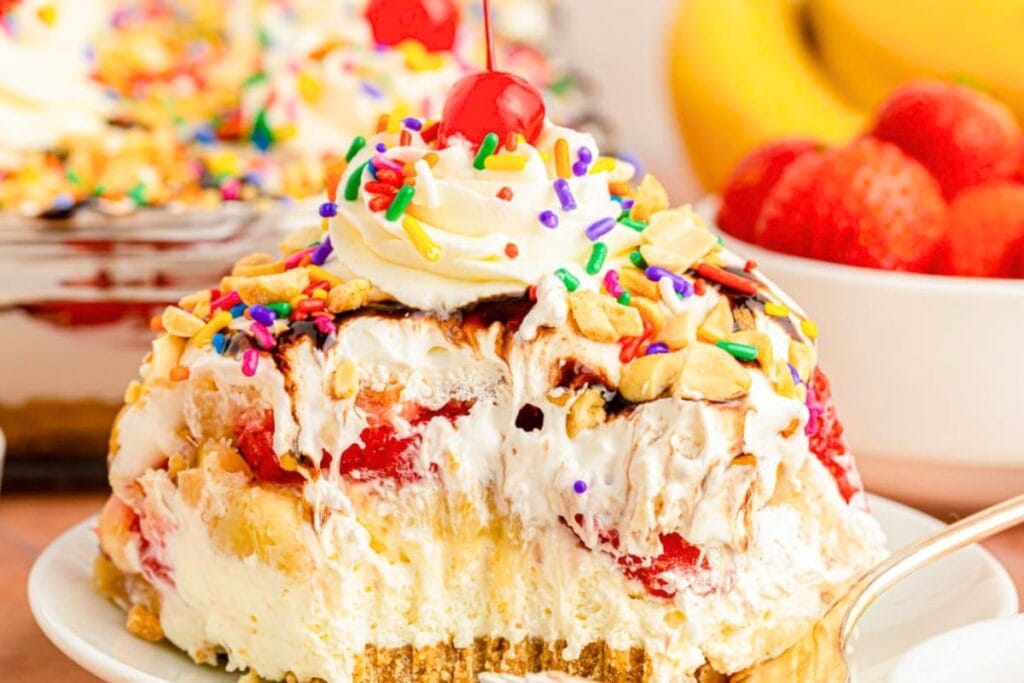 Banana split icebox cake topped with a cherry