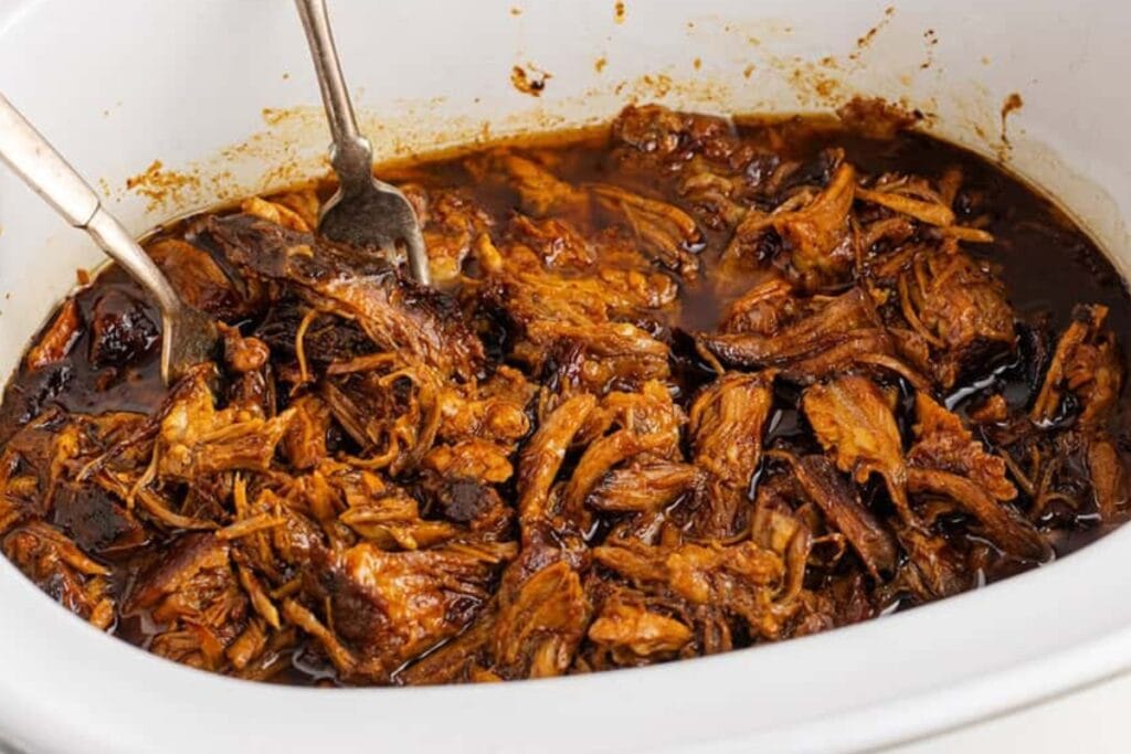 BBQ pulled pork with root beer in a slow cooker.