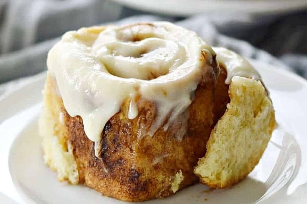A single cinnamon roll on a plate.