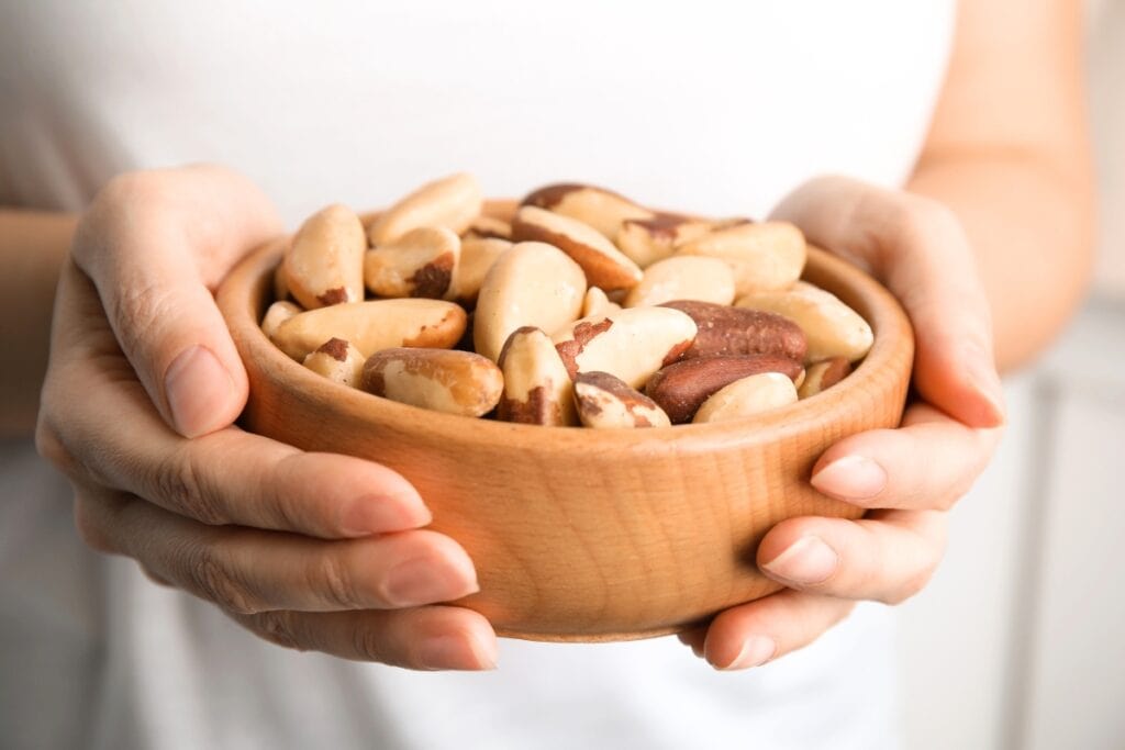 Carried wooden bowl of Brazil nuts.