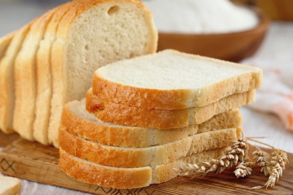 Slice bread on a wooden board.
