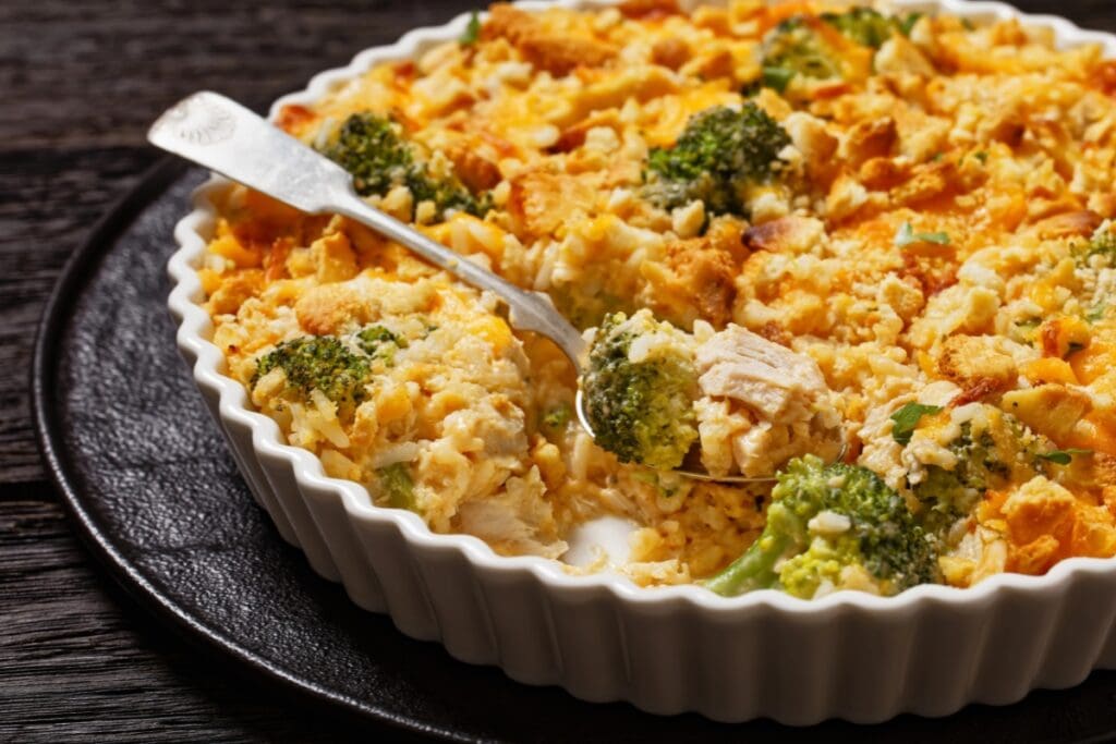 Broccoli rice casserole in a white round baking dish.