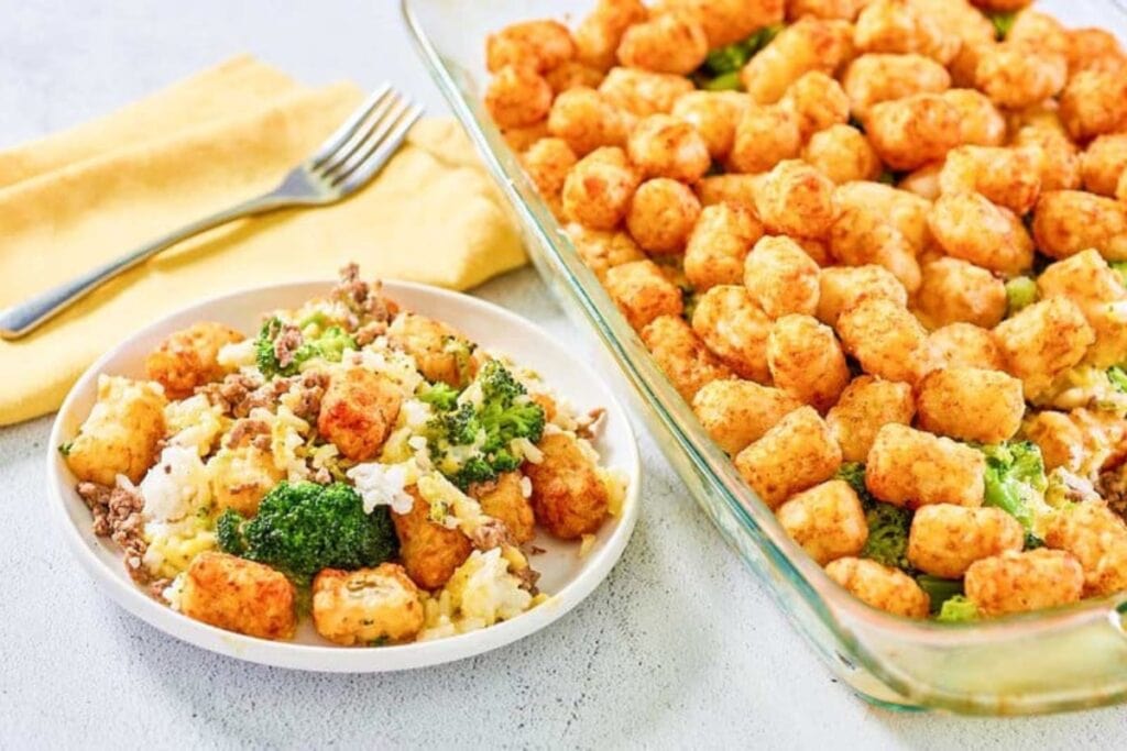 Broccoli tater tot casserole in a glass baking dish and on a white plate.