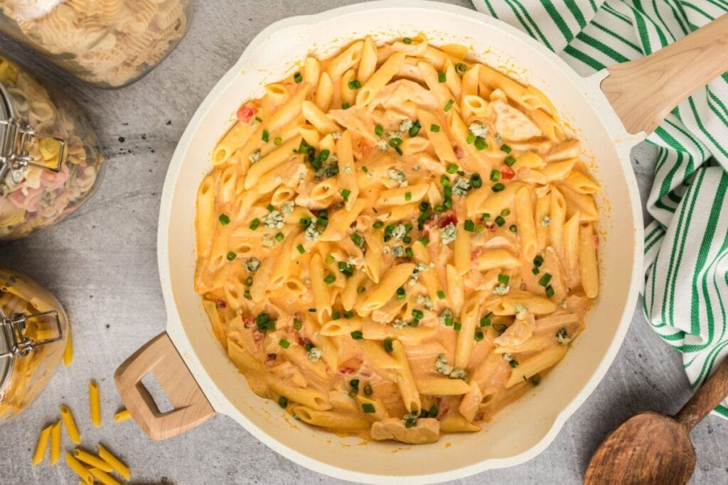 Buffalo chicken pasta in a white skillet.