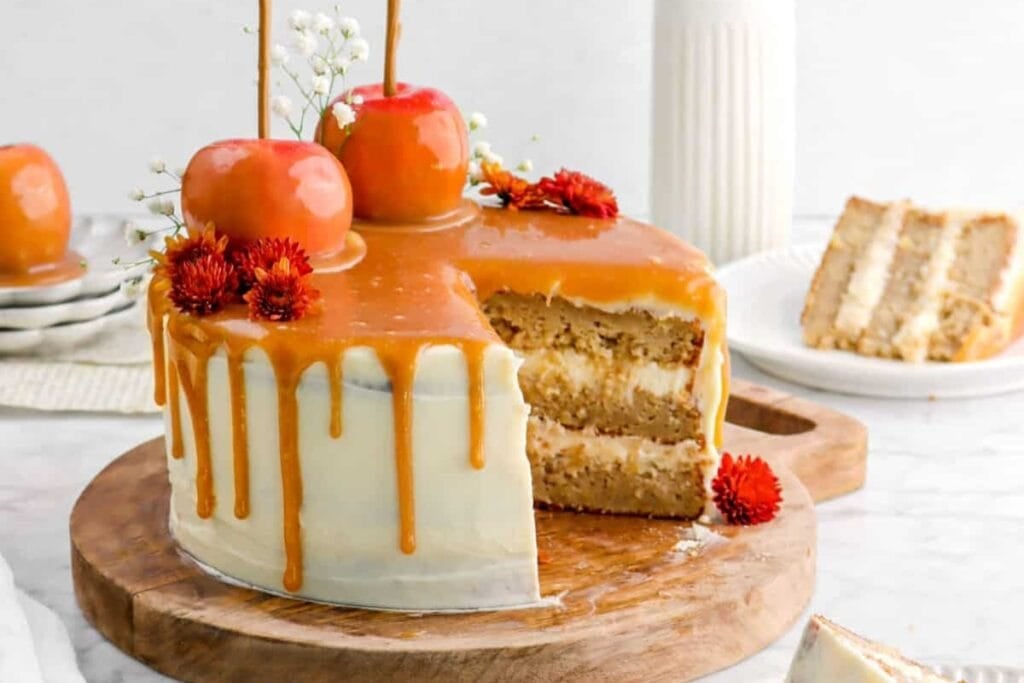 Caramel apple layer cake placed on a wooden board.