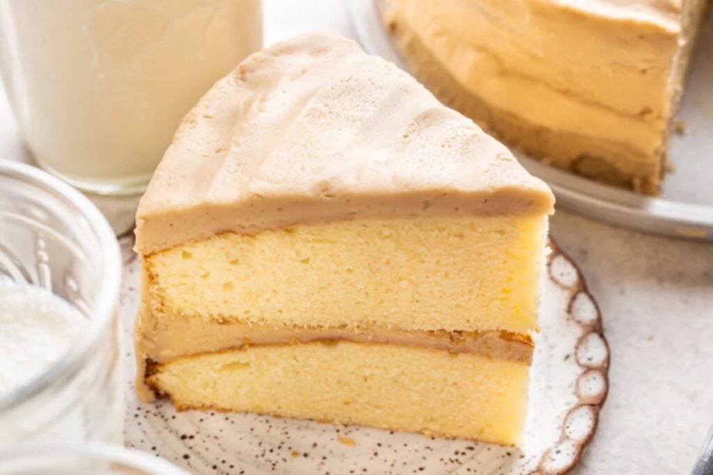 Slice of caramel cake on a plate.