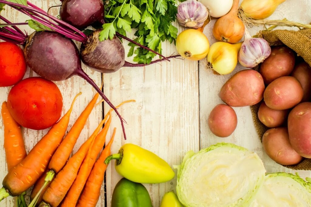 Assorted inexpensive vegetables on a wooden table.