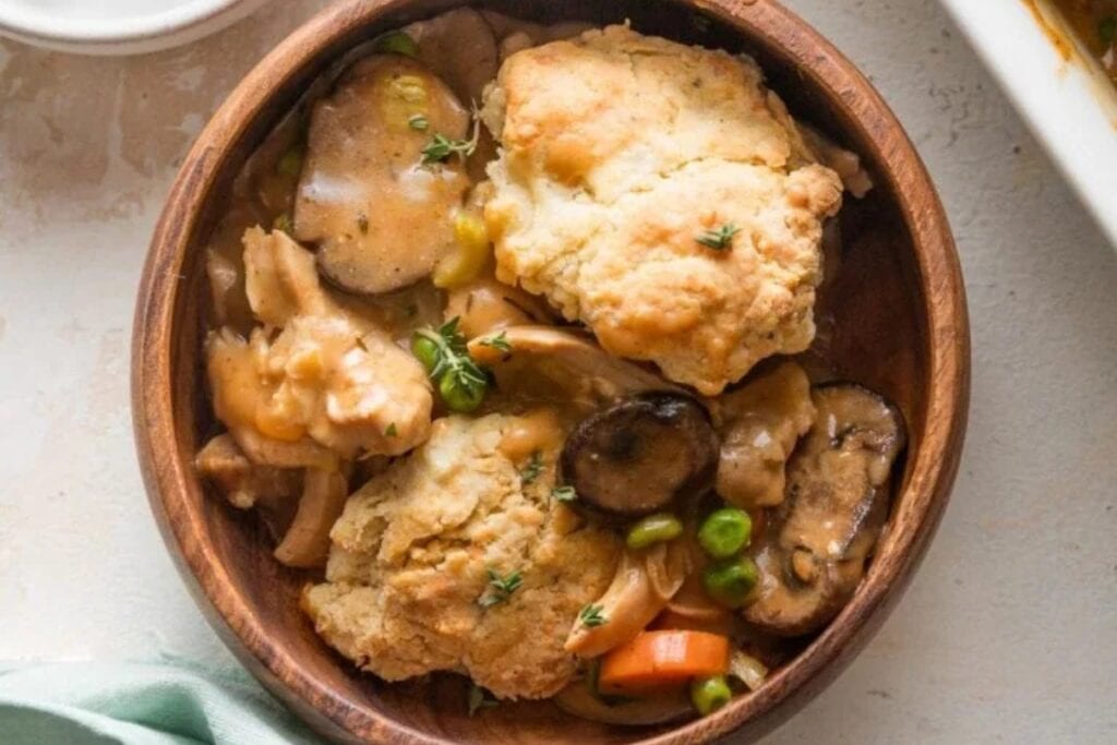 Chicken pot pie with biscuit crumble in a bowl.