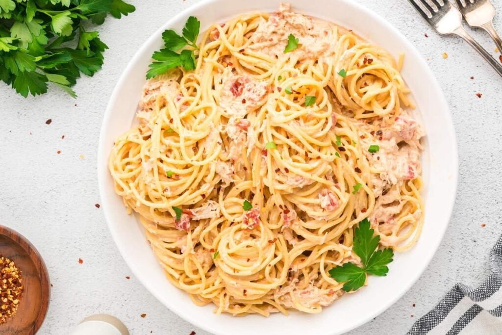 Chicken spaghetti on a white plate.