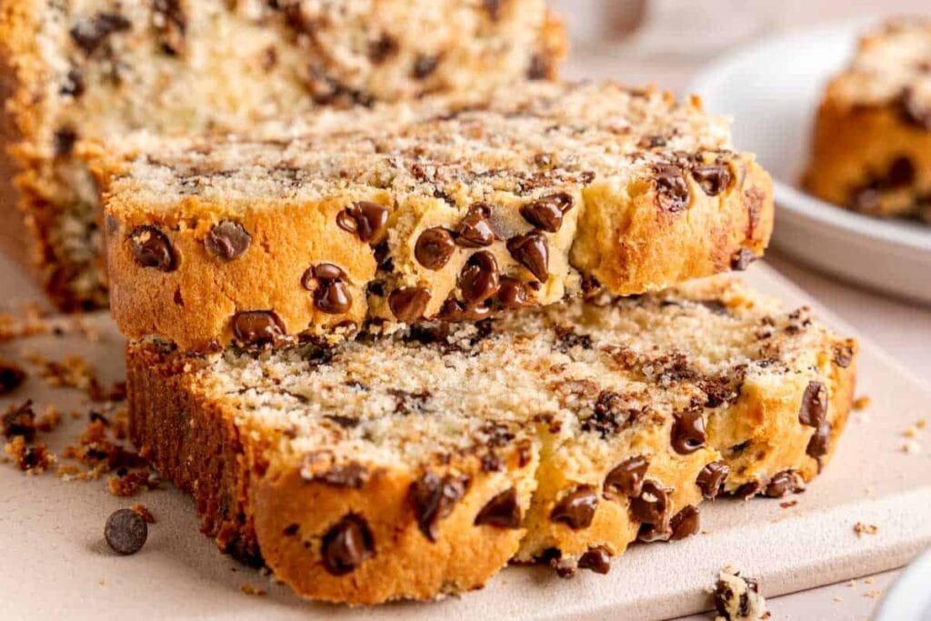 Slices of Chocolate Chip Loaf Cake on a plastic board.