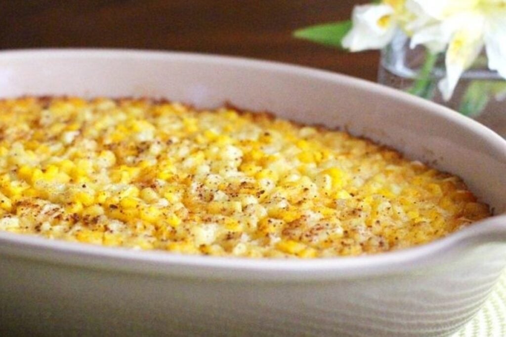 Corn pudding soufflé baked in an oval dish.